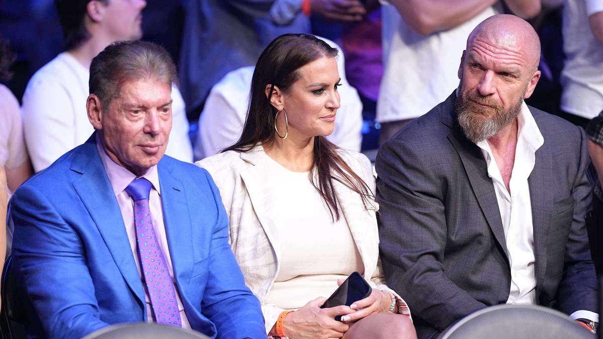 Stephanie McMahon with Vince McMahon and Triple H