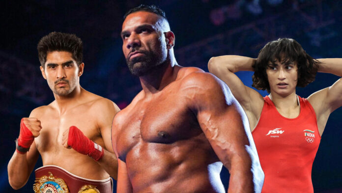 Olympic medalist Vijendar Singh (left) and Vinesh Phogat (right) with Jinder Mahal (center)